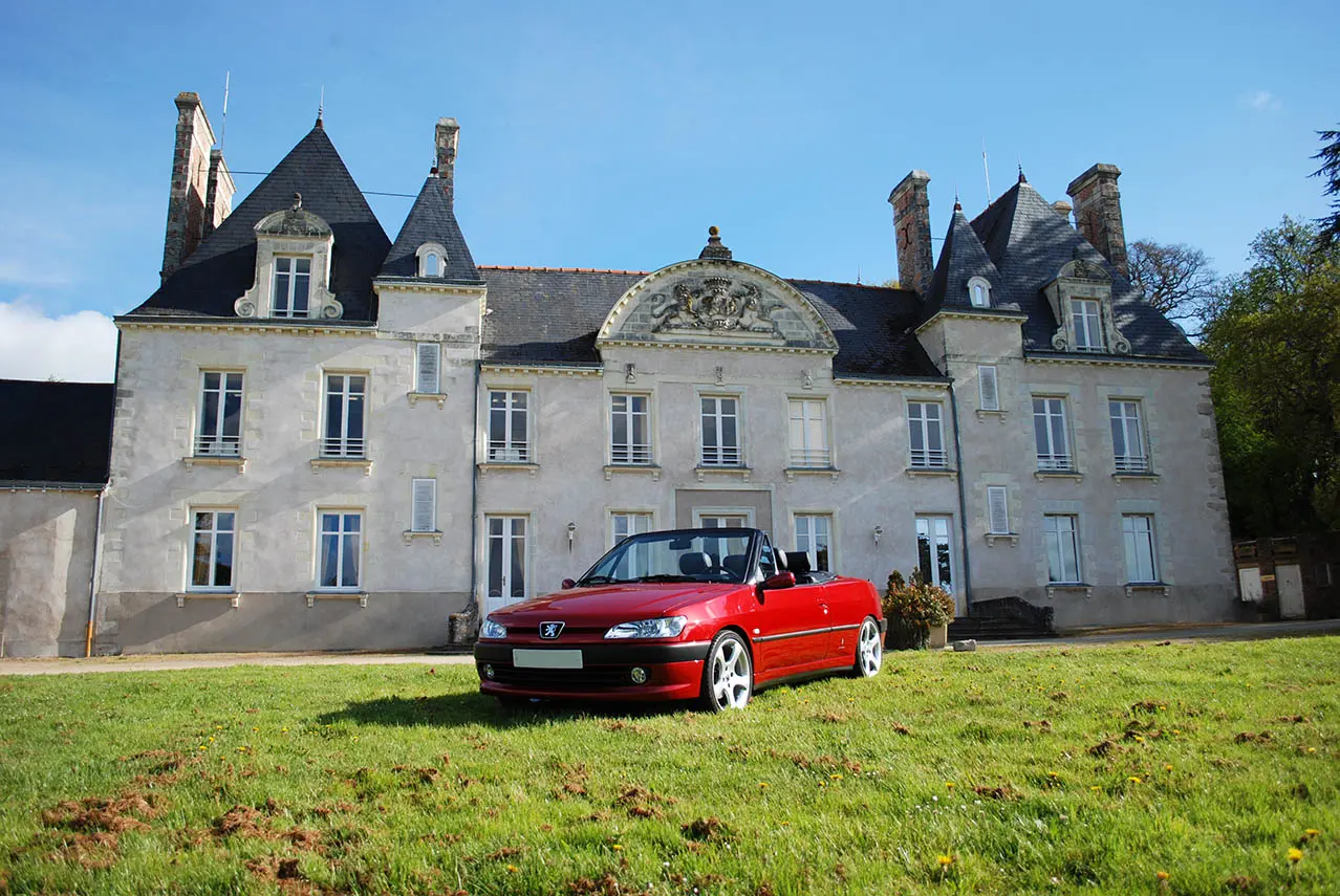 Red Car in Front of Castle